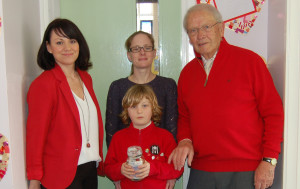 William donating the money to John Osbourne, with his  assistant headteacher Siobhan Waterhouse, and mother Lorraine.