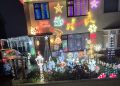 Family collects food donations with Christmas lights display